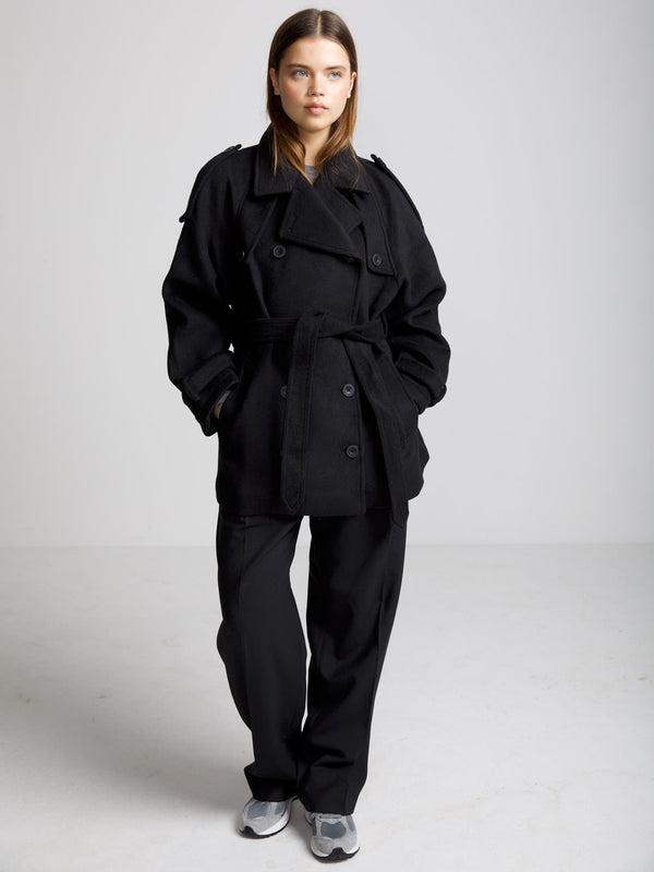 Dame i en stilren svart jakke fra MEOTINE, perfekt for enhver anledning med moderne snitt og komfort.